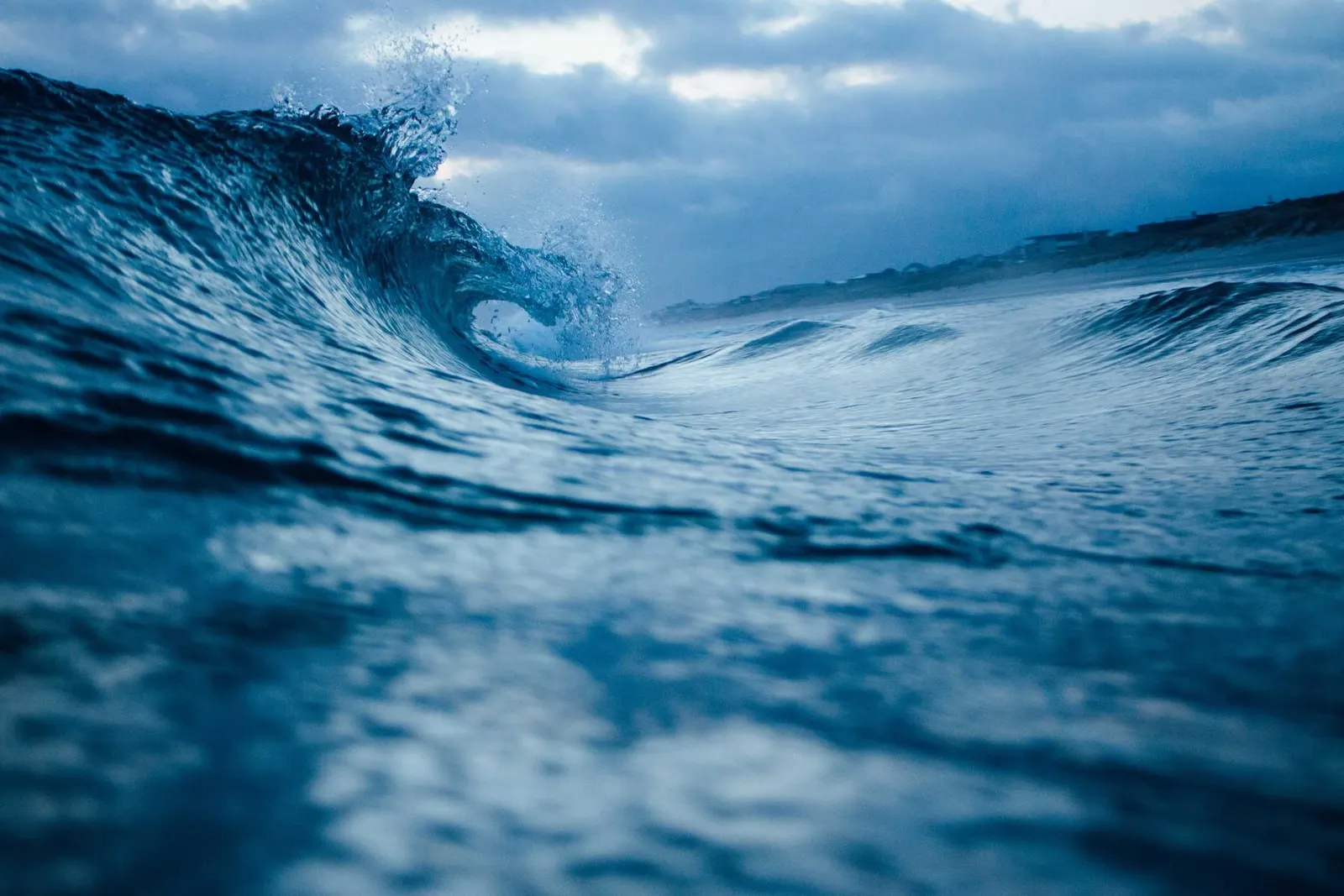 A deep blue wave curling close to the camera