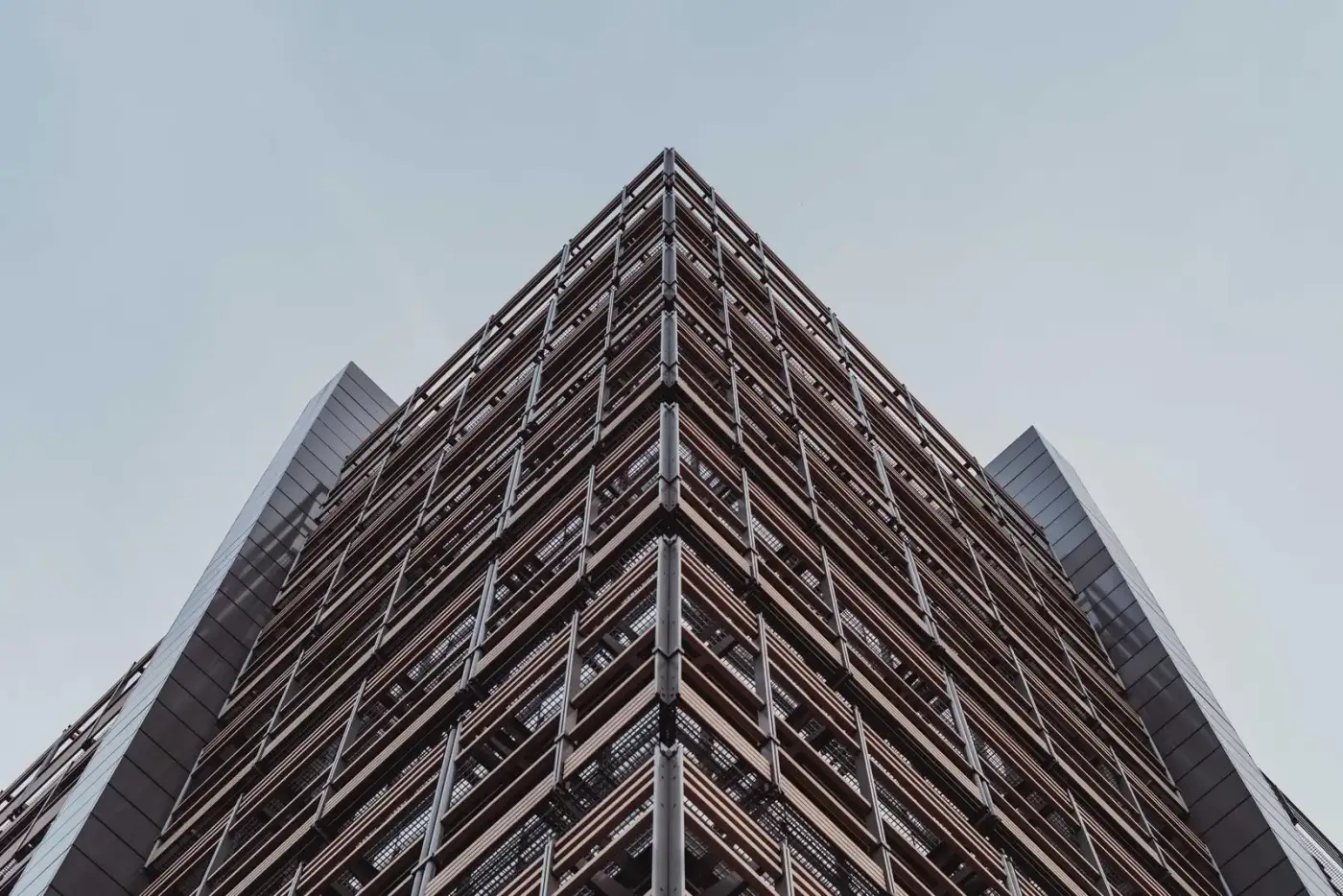 A dark facade with a sharp triangular corner